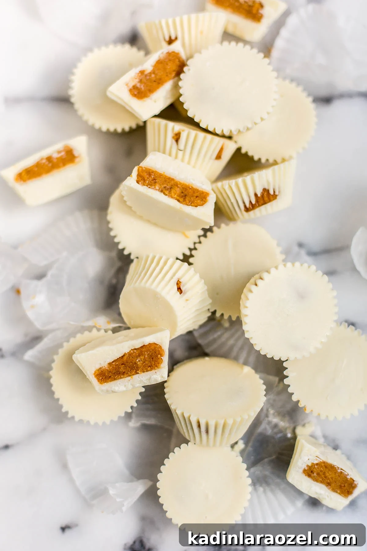 stacked white chocolate pumpkin pie candies on a marble countertop