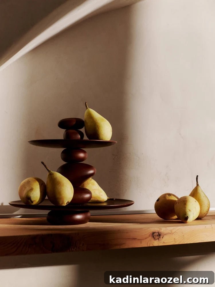 Effortless Thanksgiving Decorating Ideas 11 pears on a table with a statement dessert stand made of wood