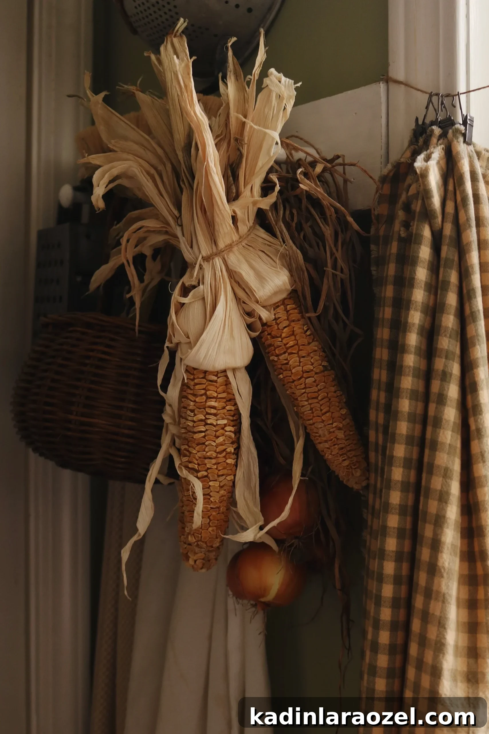 Effortless Thanksgiving Decorating Ideas 14 dried corn hanging from a shelf, with other fall decor