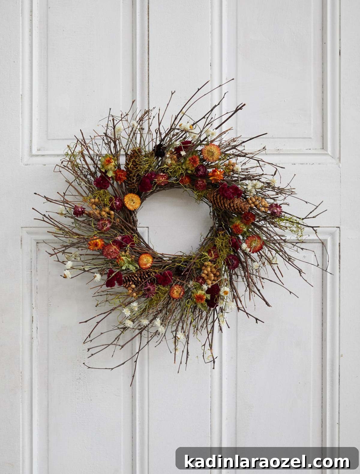 Effortless Thanksgiving Decorating Ideas 3 dried flower wreath for fall, hanging on white door