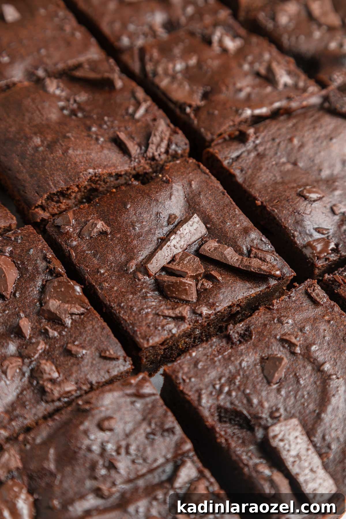 Homemade sweet potato brownies, closeup and cut into squares with chocolate chunks on top