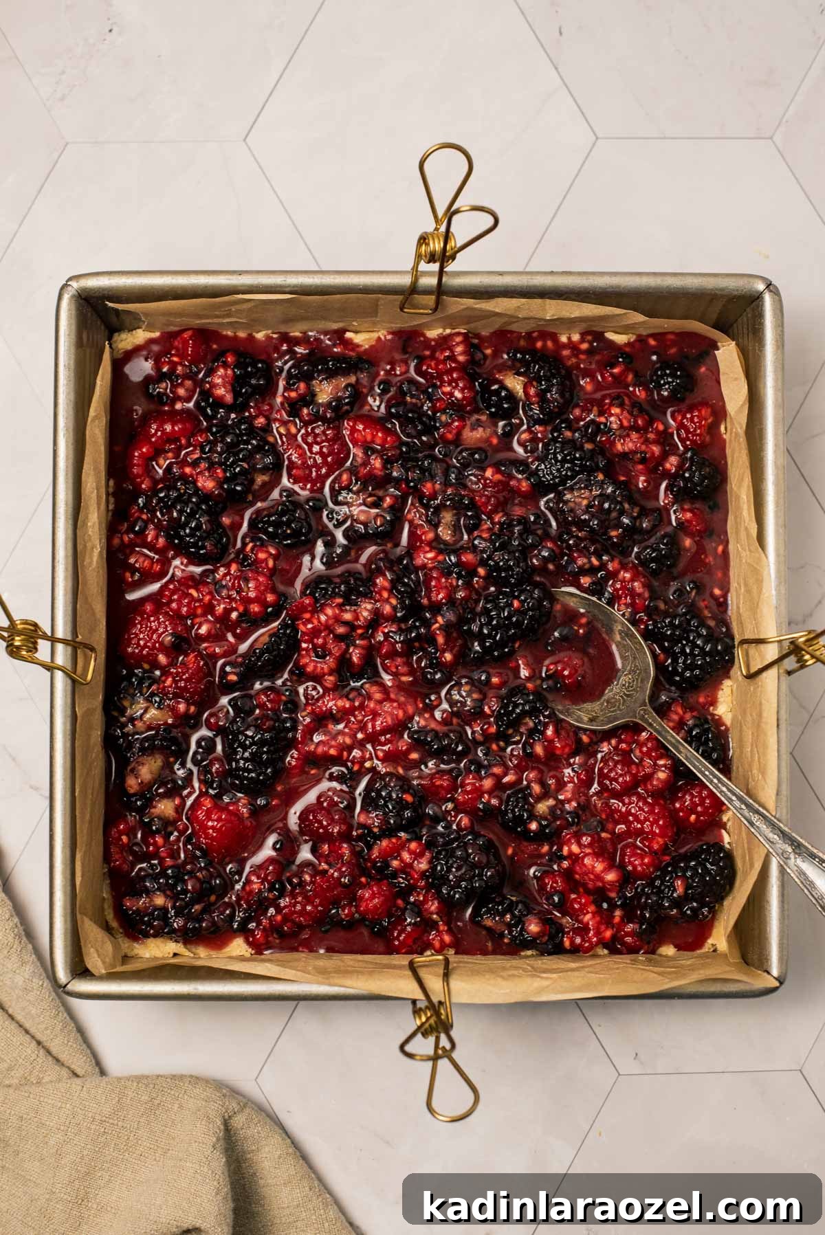 Berry Oat Shortbread Bars — Tender Crust with Fresh Berries 6 mixed berries in a square baking pan with parchment inside