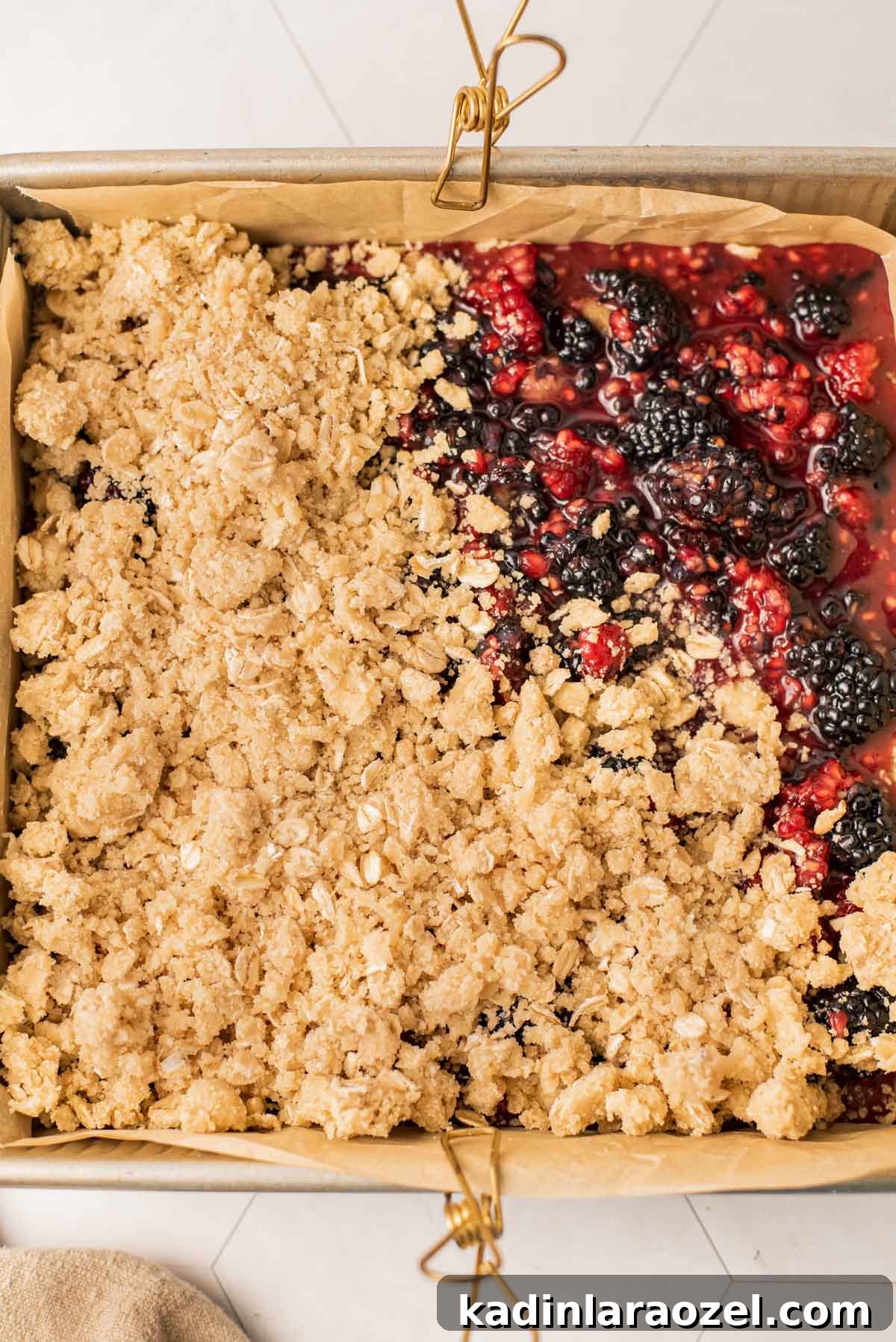 Berry Oat Shortbread Bars — Tender Crust with Fresh Berries 7 adding shortbread crumble to the top of winter dessert bars