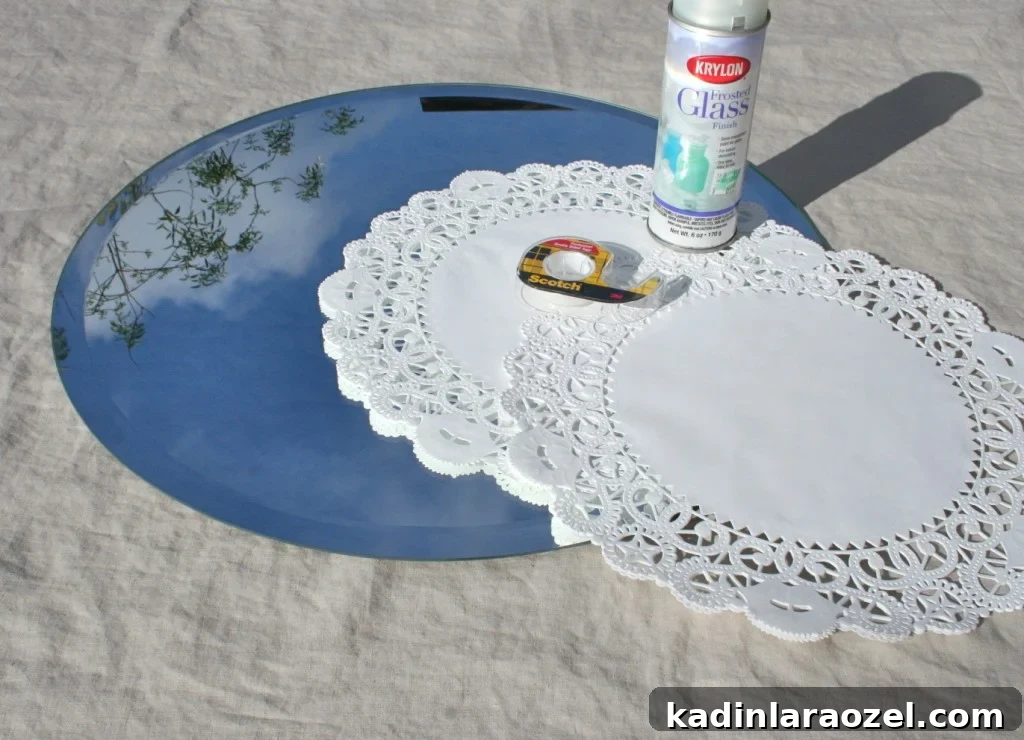 Materials needed to make a frosted glass doily mirror