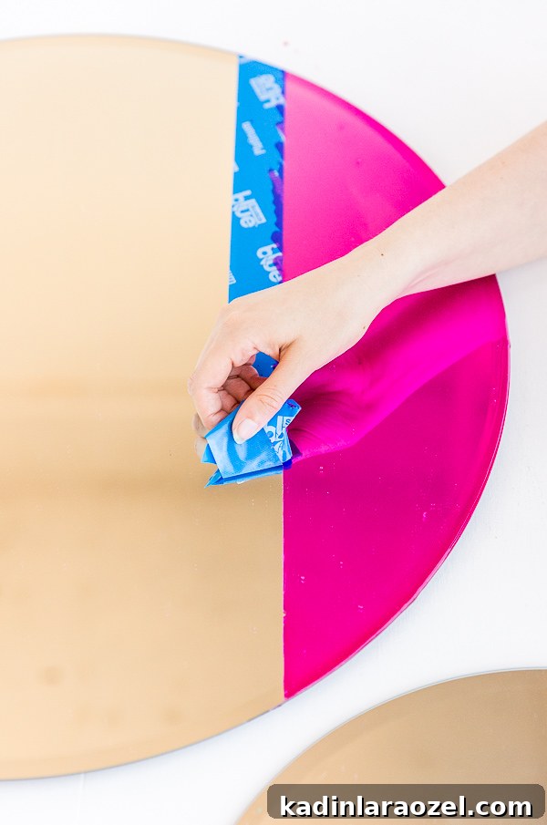 Removing tape after color blocking a mirror with special paint.
