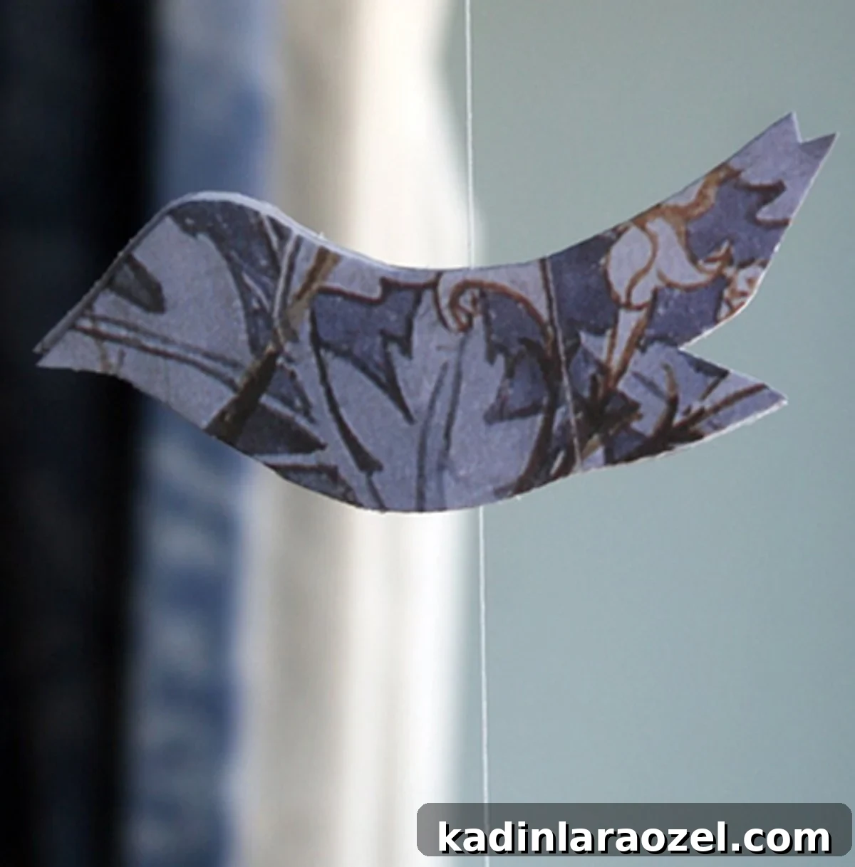 DIY Hanging Bird Mobile: Easy Step-by-Step Guide 2 Closeup detail of recycled paper shaped like a bird and turn into a hanging mobile