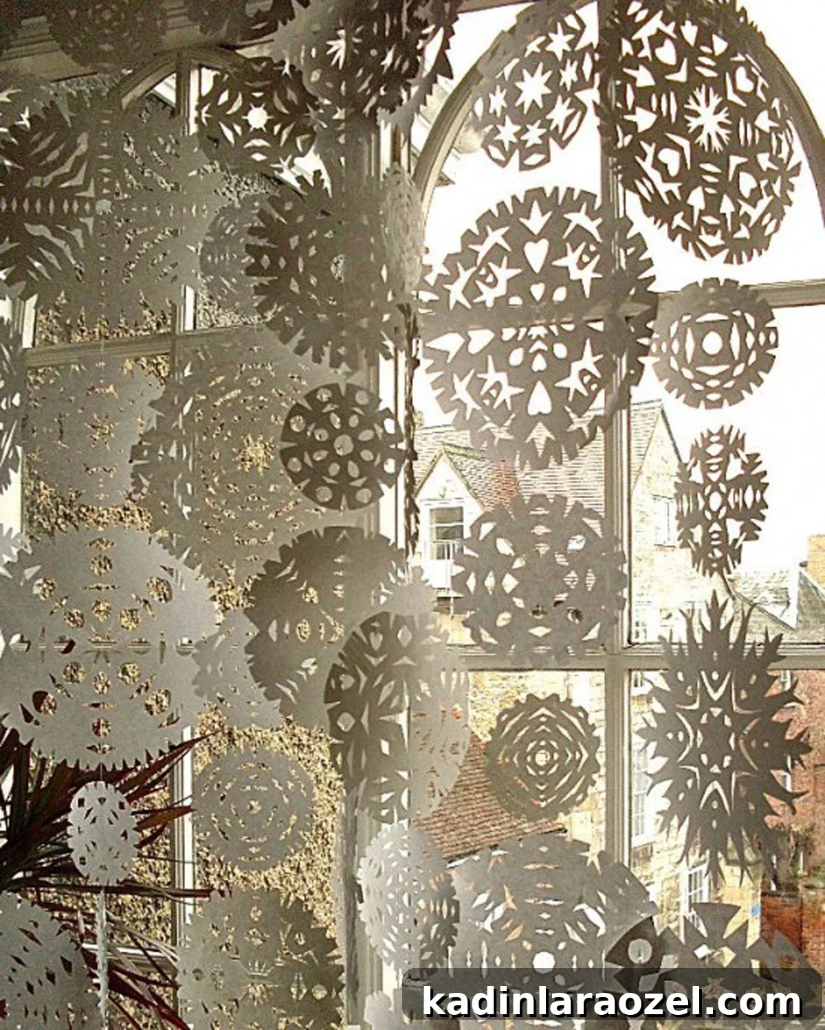 snowflakes in the window (diy) Large paper snowflakes in various sizes, covering a giant window from the interior