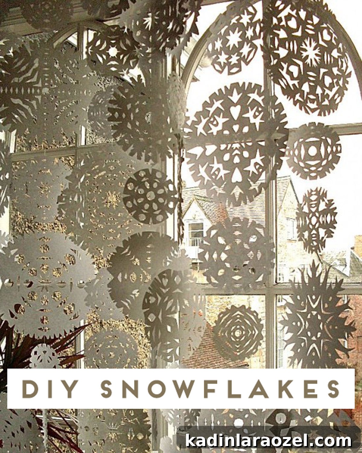 How to Make Paper Snowflakes: Simple Step-by-Step Craft Tutorial 2 Huge window with giant paper snowflakes hanging from floor to ceiling
