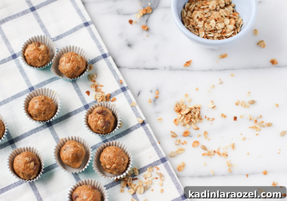 Organic Peanut Butter Protein Balls — Quick No-Bake Snack 3 Energy balls in mini cupcake wrappers on marble countertops
