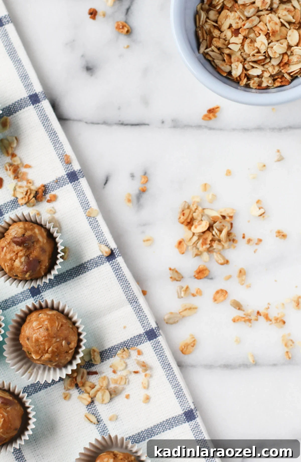 Organic Peanut Butter Protein Balls — Quick No-Bake Snack 5 Peanut butter energy balls with oats spilled out on marble counter