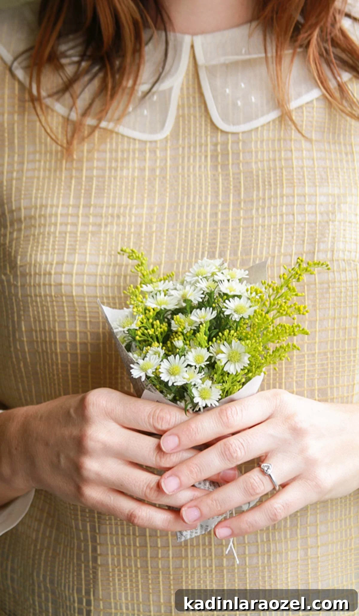 woman with beige dress and peter pan collar holding small flower bouquet