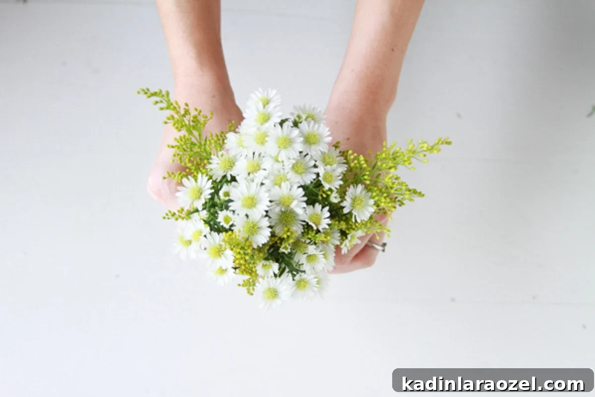 woman holding tiny bouquet of yellow and white flowers