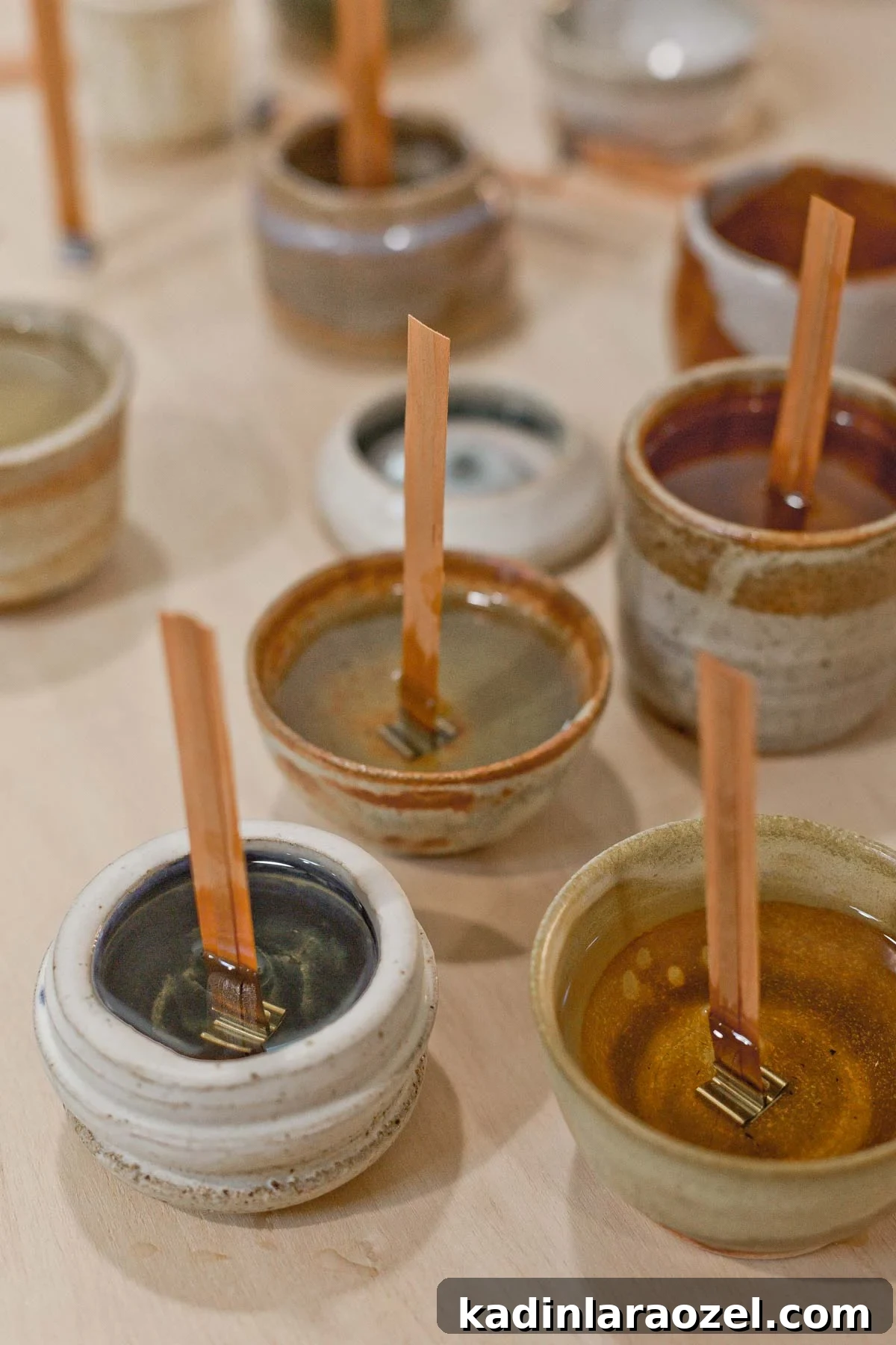 Complete Guide to Crafting Soy Candles at Home 5 Melted wax in small pottery with wooden wicks, waiting for candle wax to dry