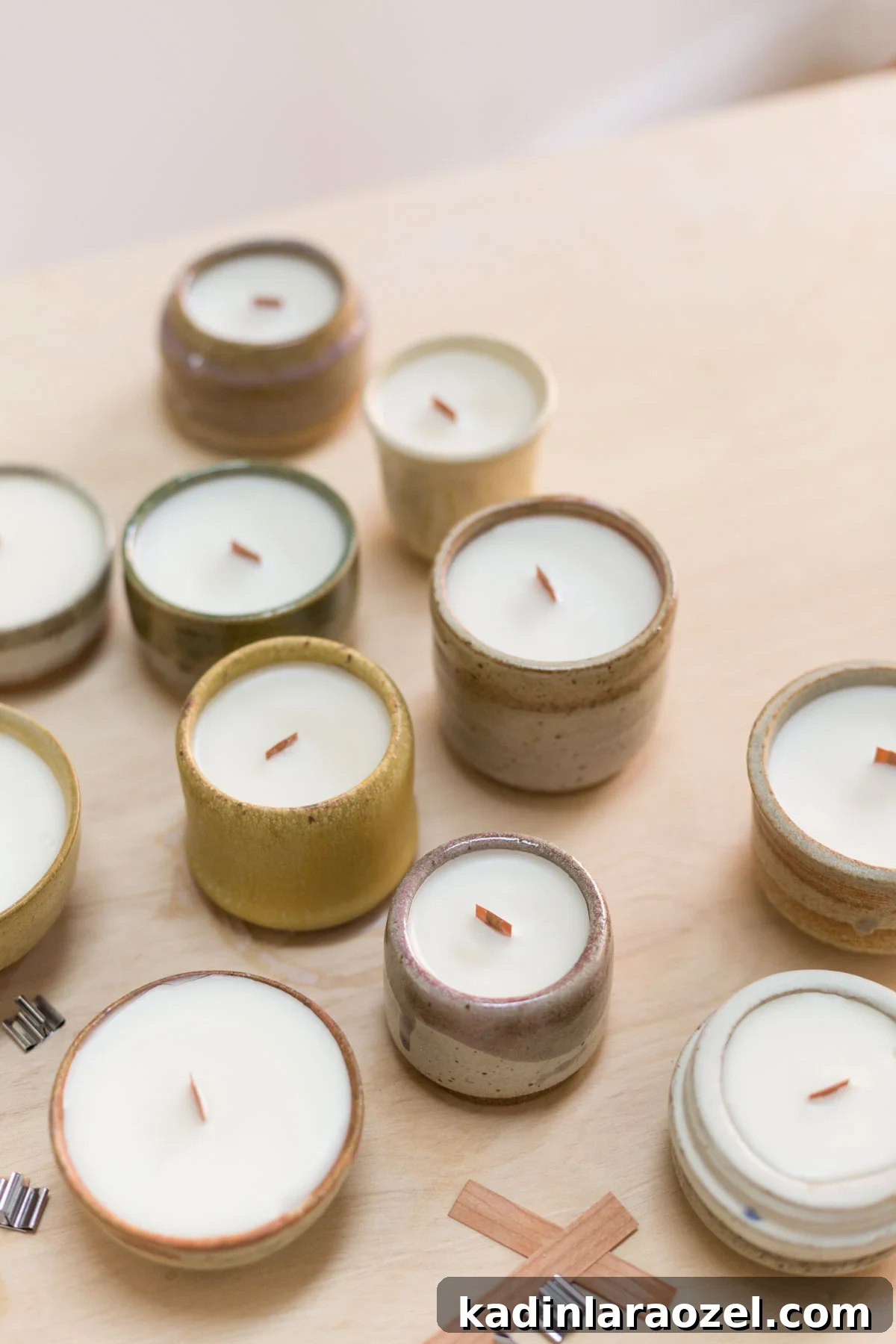 Complete Guide to Crafting Soy Candles at Home 9 Earthy potted candles sitting on a wood table with candle making supplies