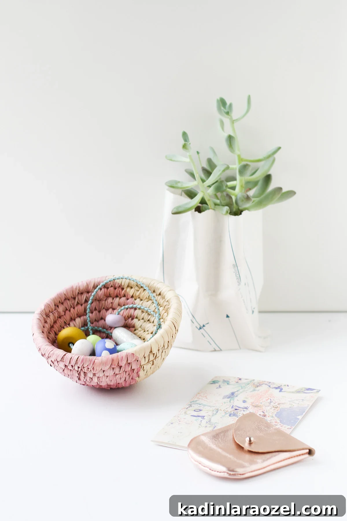 10-Minute Dip-Dyed Woven Baskets DIY Tutorial 6 Color blocked woven basket holding jewelry, on top of a white desk