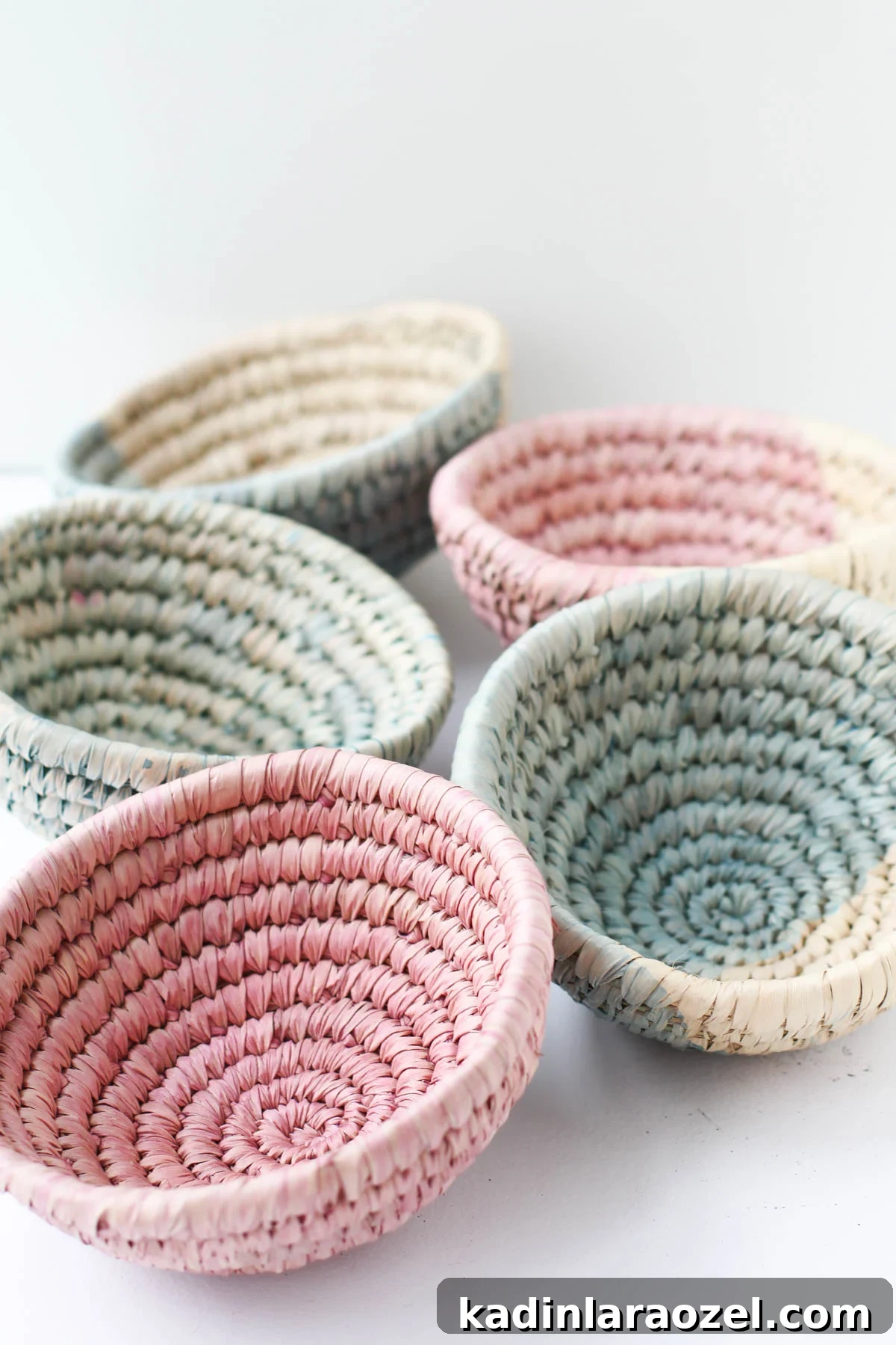 10-Minute Dip-Dyed Woven Baskets DIY Tutorial 7 Woven baskets dip dyed in various muted colors, left on a table to dry