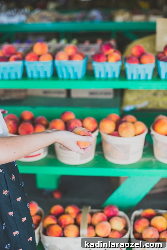 fruit stand farmers market with green shelves and wooden baskets filled with peaches