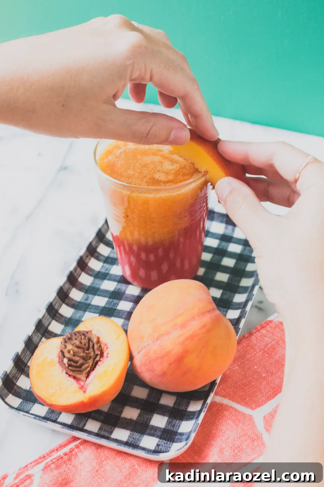 Adding a peach garnish to a frozen cocktail.