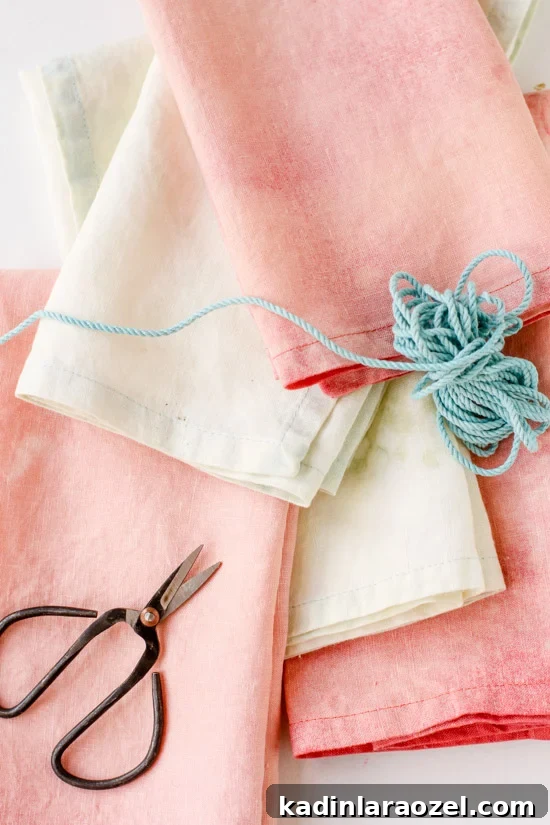 Pretty pink and pastel linens closeup, with scissors and thread.