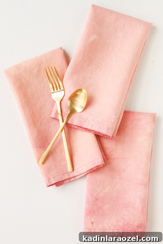 Pink bleached linen napkins with gold silverware.