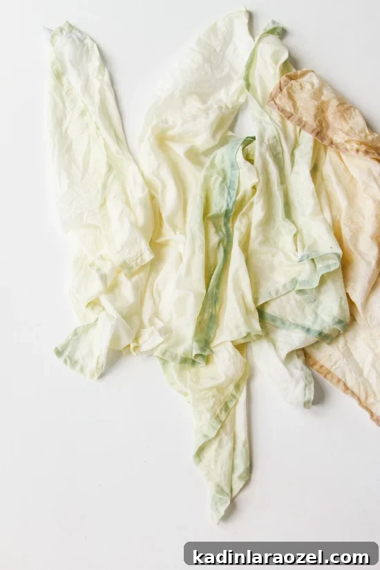Bleached linen napkins in pastel colors on a white table.
