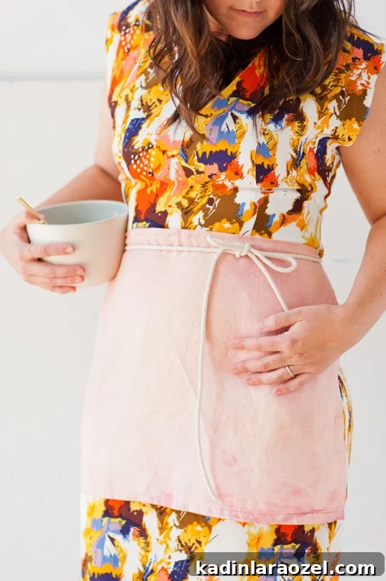 Linen cafe apron, worn by brunette wearing a dress.