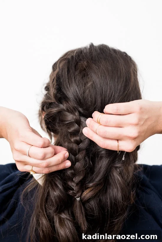 Quick Reverse Crown Braid Tutorial: Stylish Look in 15 Minutes 4 Woman braiding her hair to create a reverse crown braid