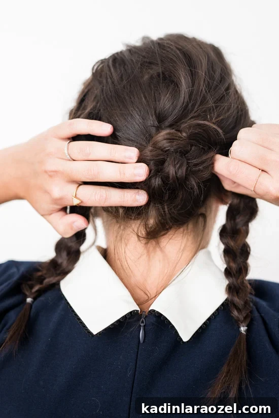 Quick Reverse Crown Braid Tutorial: Stylish Look in 15 Minutes 5 Woman twisting her hair into a bun with a braid