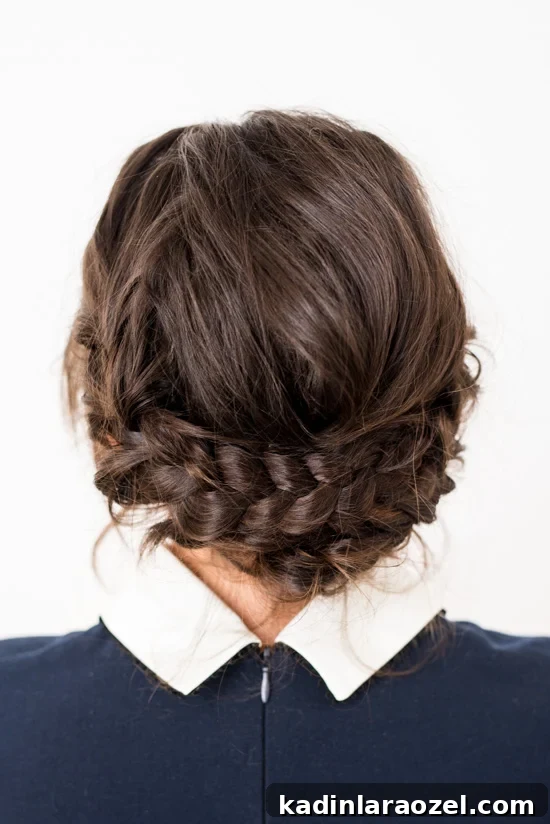 Quick Reverse Crown Braid Tutorial: Stylish Look in 15 Minutes 9 Woman with brown hair with a reverse crown braid, wearing a dress