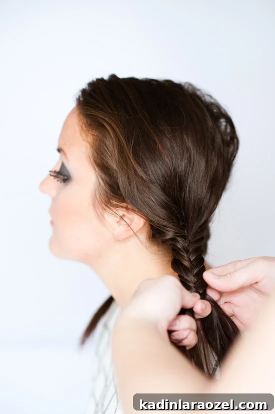 Image of creating fishtail braids for a Wednesday Addams costume.