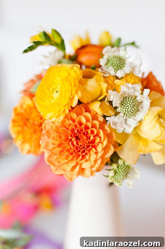 5 Budget DIY Ways to Color Your Dinner Table 12 A colorful Thanksgiving centerpiece with ranunculus and dahlias.