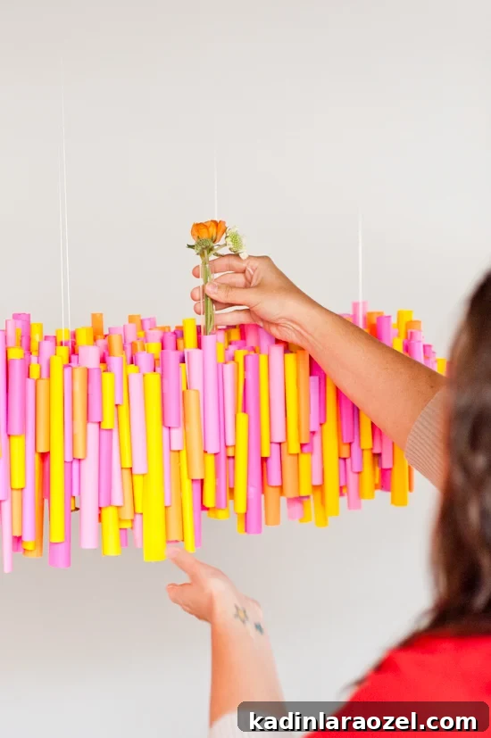 5 Budget DIY Ways to Color Your Dinner Table 5 Make this DIY hanging chandelier made of rolled up pieces of paper and wrapped test tubes for vases.