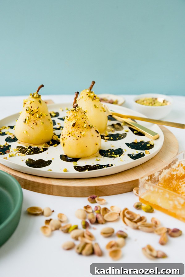 Recipe for boozy poached pears with drizzled honey and pistachios