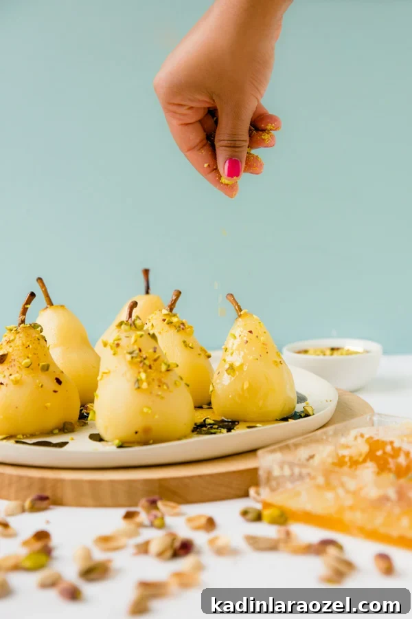 Recipe for boozy poached pears with drizzled honey and pistachios