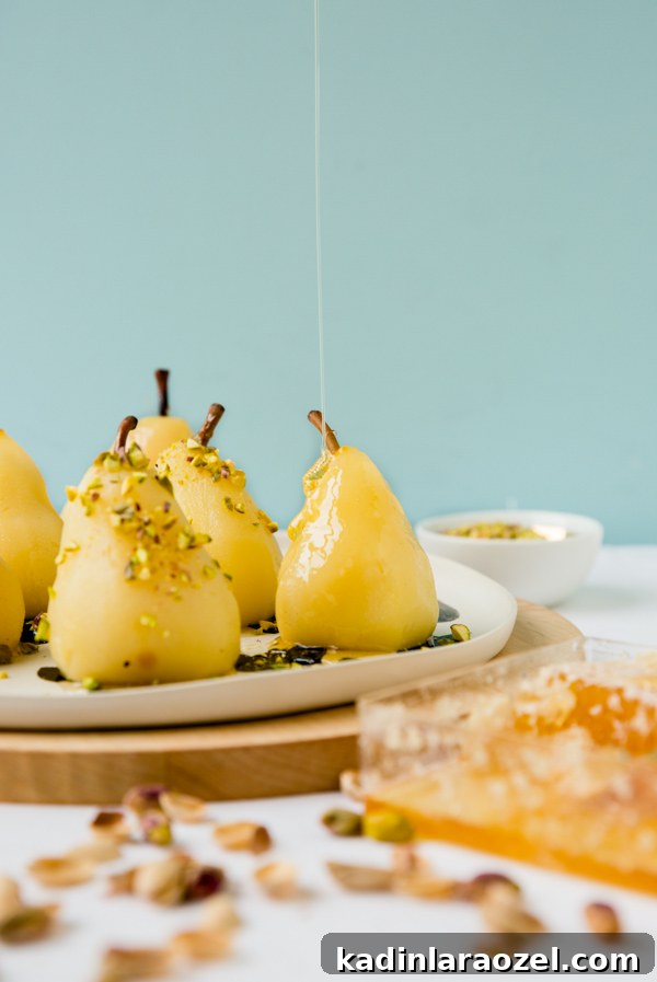 Boozy poached pears with drizzled honey and pistachios