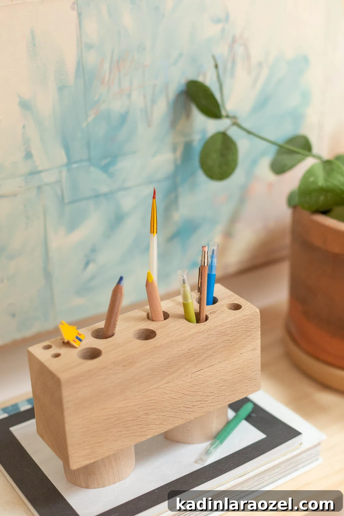 DIY Pencil Holder Makeover: Stylish Steps to Upcycle a Holder 2 Wood pencil organizer on wood desk with books and plants