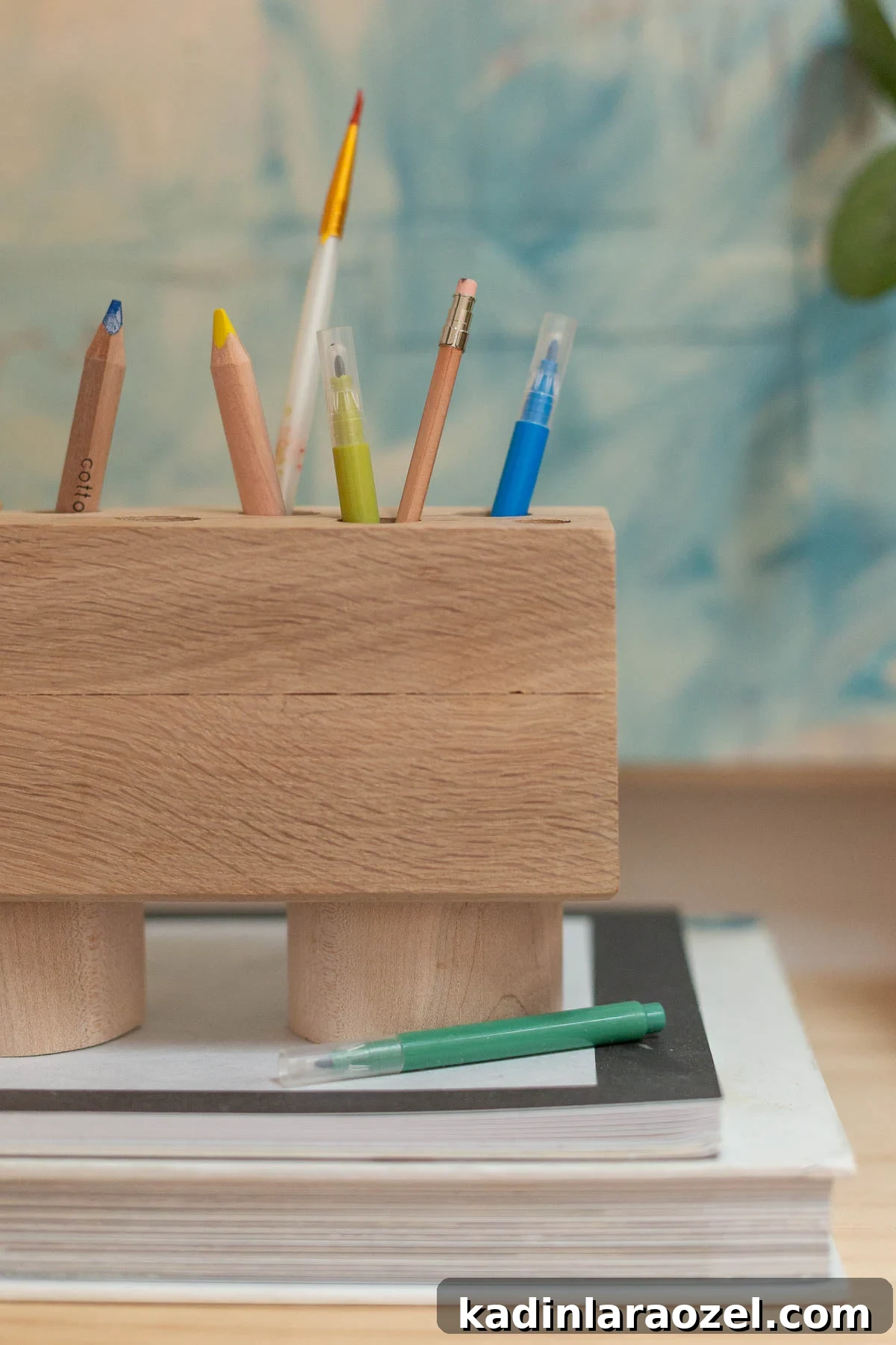 DIY Pencil Holder Makeover: Stylish Steps to Upcycle a Holder 11 Wood desk organizer with pens and pencils on top of books
