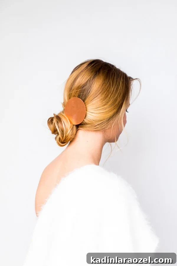 How to Create a Side-Swept Chignon: Step-by-Step Tutorial 7 Blonde woman wearing low bun with backless dress