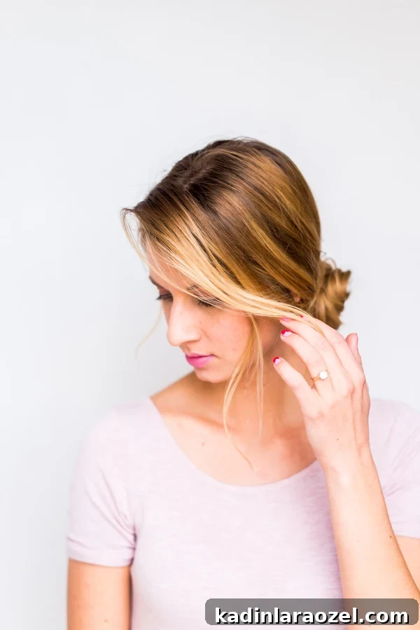 How to Create a Side-Swept Chignon: Step-by-Step Tutorial 9 Profile of woman wearing low chignon bun with pink dress
