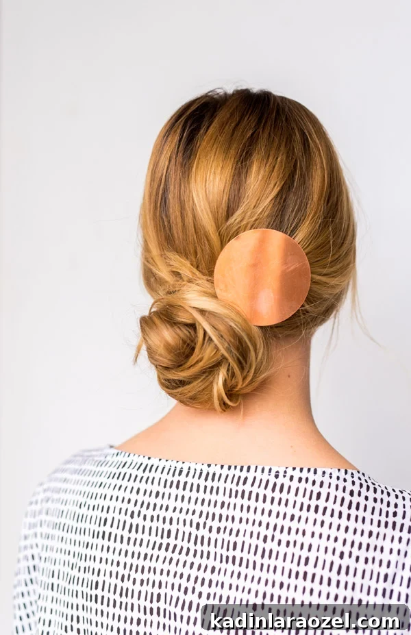 How to Create a Side-Swept Chignon: Step-by-Step Tutorial 10 Back view of women wearing hair up in chignon bun, wearing black and white dress