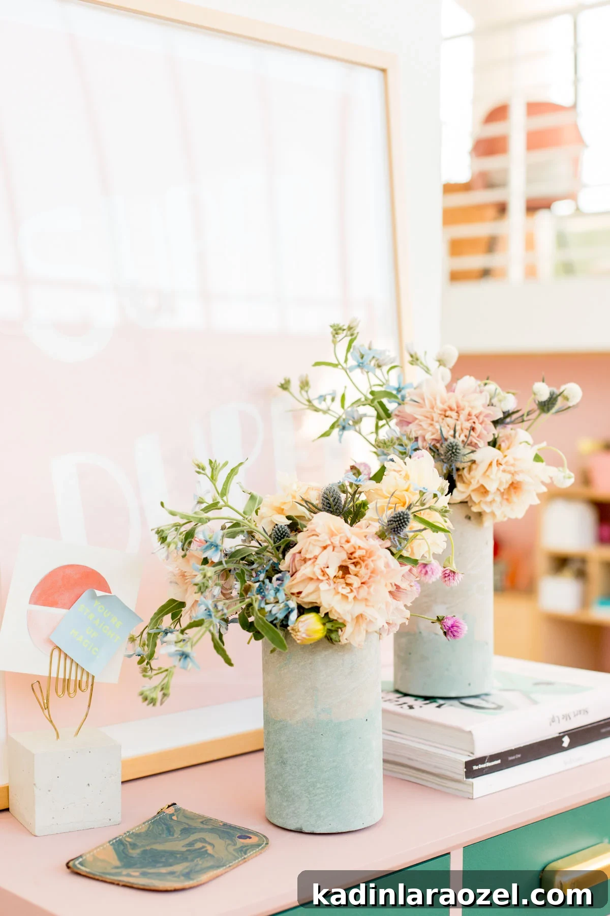 Coloring Concrete: Step-by-Step Guide to Make a Stylish Concrete Vase 2 Two concrete vases with colorful floral bouquets, sitting on a desk in a loft space