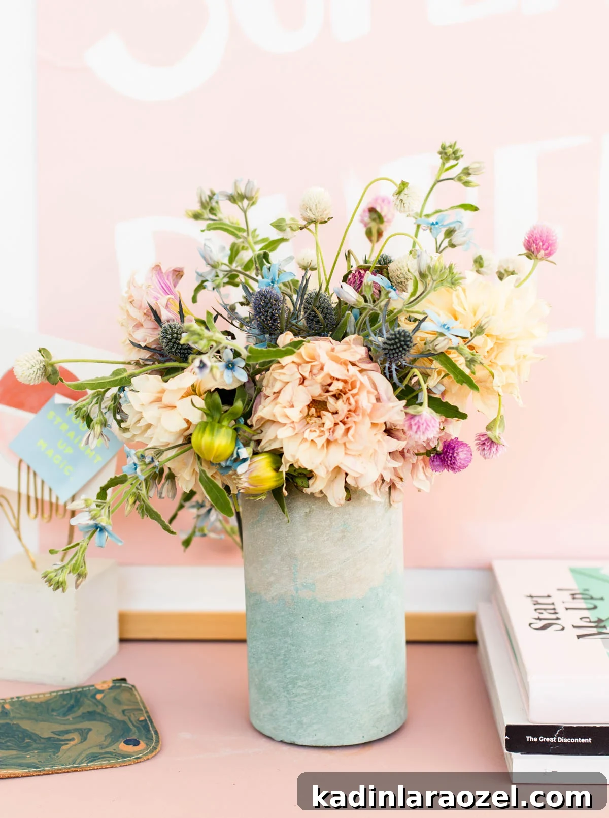 Coloring Concrete: Step-by-Step Guide to Make a Stylish Concrete Vase 3 DIY concrete vase with beautiful bouquet sitting on a pink dresser with pink artwork behind it