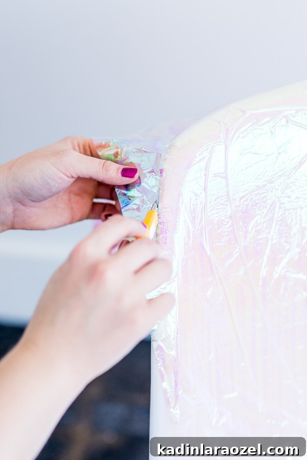 From Dumpster Find to DIY Holographic Accent Chair: Step-by-Step Guide 7 Securing and trimming holographic paper on a chair