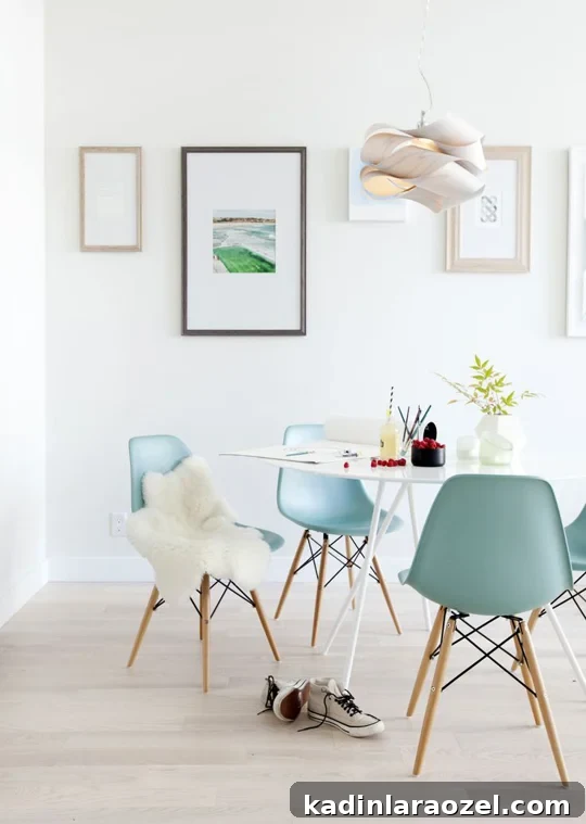 Light and bright dining space with blue Eames chairs and a simple white table.