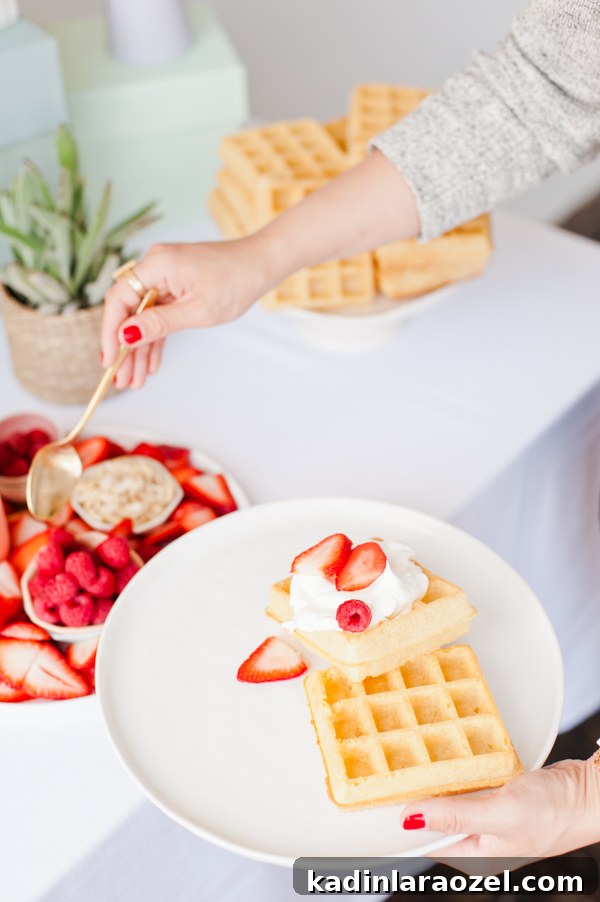 A waffle bar with fresh fruit and whipped cream for a DIY Mother's Day brunch
