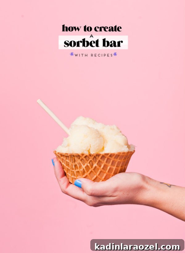 3 Refreshing Vegan Sorbet Recipes + DIY Colorful Sorbet Bar Guide 2 scoops of grapefruit sorbet in a waffle cone bowl, being held in a woman's hand, pink background