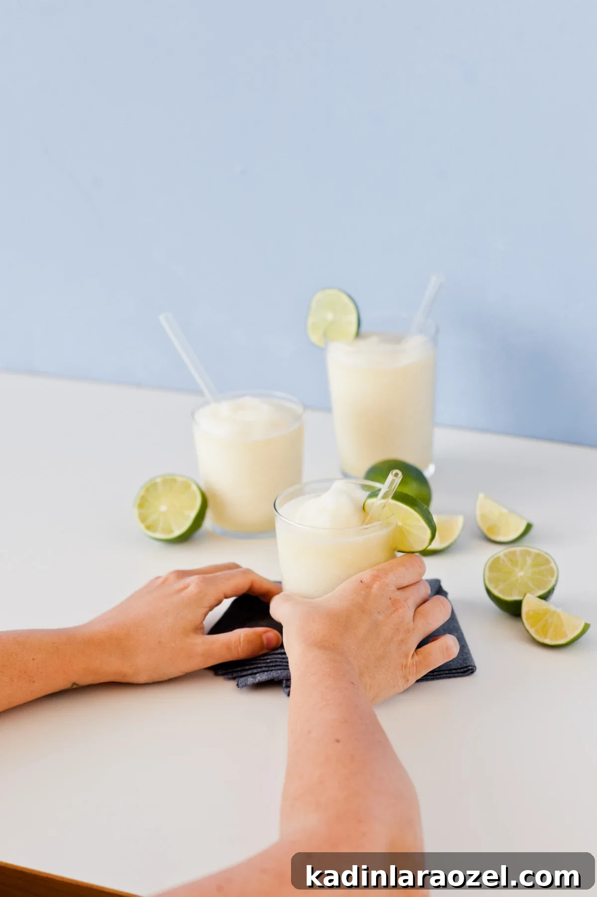Gin and Juice Slushie Recipe: Refreshing Frozen Cocktail Guide 9 Moving gin and juice slushie onto white table with limes