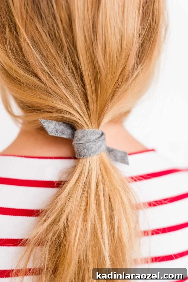 Create a Sleek Ponytail in 3 Minutes Using Felt 2 Blonde woman with effortless ponytail with grey scrunchie
