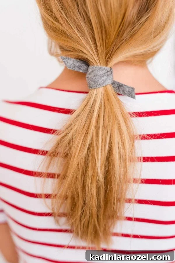 Create a Sleek Ponytail in 3 Minutes Using Felt 8 Closeup of low ponytail on blonde woman, tied with felt