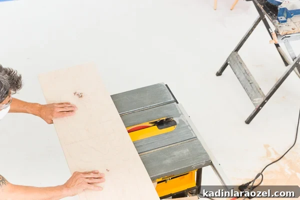 Modern Studio Makeover: DIY Seating and Storage Before & After 6 Cutting wood on table saw from above